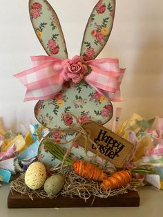 an easter decoration with eggs, carrots and flowers