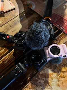 a camera and microphone sitting on top of a wooden table