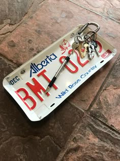 a license plate with some keys attached to it