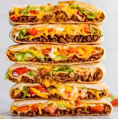 four tacos stacked on top of each other