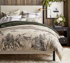 a bedroom with a bed, nightstands and plants on the wall behind it is decorated in wood paneling