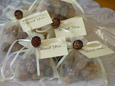 small pine cones wrapped in organ bags with thank you tags