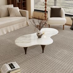 a living room with two chairs and a coffee table in the middle of the room