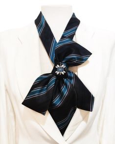 Statement blue necktie necklace for women made from an Italian silk tie. The striped pattern of the tie combines navy blue, sky blue, turquoise, dark brown and white. The shape of the bow it forms is very feminine and flattering. Small crystal ornament complete this unique design. This accessory will be a great gift for someone special or will complete your most sophisticated looks. ❈ DETAILS: * Handmade in Andalusia, Spain * Length: 16.54 inches - 42cm  * Adjustable neck measurement with extend Blue Formal Tie With Ribbon Detail, Formal Blue Tie With Ribbon Detail, Upcycle Ties, Womens Ties, Necktie Necklace, Upcycled Neckties, Navy Blue Sky, Blue Necktie, Andalusia Spain