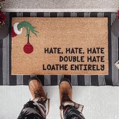 someone standing in front of a door mat that says hate, hate, double hate loathe entirely