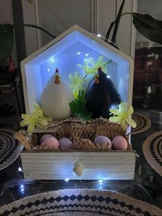 a basket with eggs in it on a table next to other plates and vases