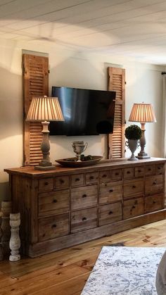 a living room scene with focus on the dresser and flat screen tv in the corner