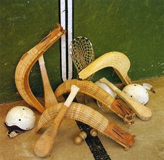 several wooden objects sitting on the ground next to a green wall