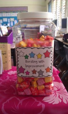 a jar filled with gummy bears sitting on top of a table