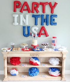 a party in the usa with red, white and blue decorations on a buffet table