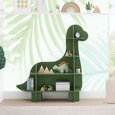 a green dinosaur book shelf in a children's room