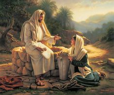 two women sitting on a stone wall talking to each other while one woman is holding a cup