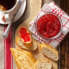 bread slices with jam on them next to a cup of coffee