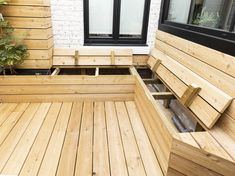 a wooden bench sitting on top of a wooden deck