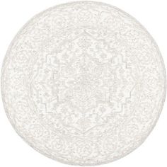 a round white rug with an intricate design