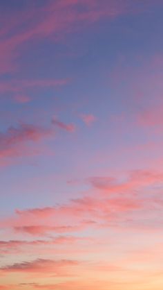 the airplane is flying high in the sky at sunset or dawn, and it's just beginning to take off