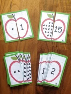 four cards with numbers and an apple on them