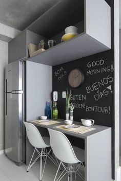 an instagram page with two chairs and a table in front of a chalkboard wall