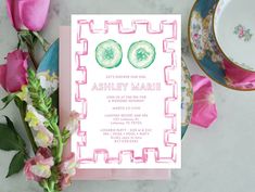 a pink and green wedding card with two slices of cucumber on the front