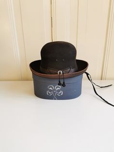 Vintage felt Spanish bowler hat, brand Barselonia, extra Finos. Size small, 49 cm. 50's or 60's. The wooden box is included (non original). What does the bowler hat symbolize? In the nineteenth century, two hat styles were popular for men. The top hat, which was a status and power symbol, and the bowler. Although originally developed for the upper class, the bowler hat became a symbol of the middle class and upward mobility. Please see pictures (and video) for an up-close inspection, as they are Hat Styles, Power Symbol, Bowler Hat, Retro Gift, Middle Class, Top Hat, Wooden Box, Hat Fashion, Melon