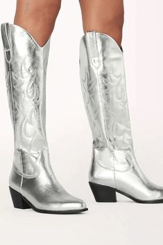 Stand out from the crowd with this statement long boot! The Urson by Billini is a long, western inspired boot. It features a low stacked block heel, wide fit long boot body, western inspired embroidery, an almond shape toe, and an eye-catching metallic silver finish. We guarantee these will quickly become your favorite way to jazz up any look! Run true to size ~ if in between sizes then we recommend sizing up Heel height is 5.5 cm Oversized side pull tabs for a pull on design Synthetic upper, li Western Ankle Boots Outfit, Black Western Boots Outfit, White Western Boots Outfit, Western Boot Outfit, Western Boots Outfit, Black Western Boots, Symbol Of Freedom, Boots Outfit Ankle, Disco Cowgirl