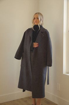 A timeless tailered oversized long wool coat for the cool-weather. The tailored wool trench coat is cut for an oversized silhouette in a longer length and finished with a tie belt. The sophisticated belted wool coat is a classic piece that you can wear with many fall and winter outfits. lapel-collar-wool-oversized-belted-handmade-long-coat Oversized silhouette Notched lapels lapel collar wool coat Welt large pockets Optional self-tie belt handmade 90% wool 10% polyester Dry clean only Model is w Large Trench Coat Outfit, Air Clothes, Belted Wool Coat, Wardrobe Revamp, Fall And Winter Outfits, Oversized Wool Coat, Wool Wrap Coat, Trench Coat Outfit, Fall Winter Trends