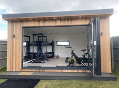 the inside of a home gym with an exercise bike and stationary bicycle in it's garage