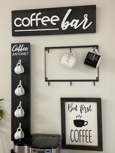 a coffee bar sign hanging on the wall next to a crock pot and an espresso machine