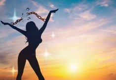 the silhouette of a woman with her arms in the air and hands out to the sun