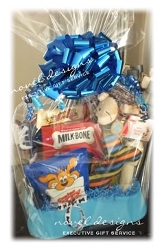 a blue gift basket filled with teddy bears and other items for someone's special occasion