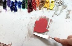 someone is using a paint brush to create a heart