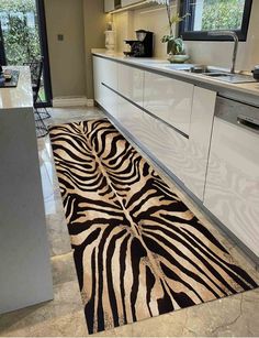 a zebra print rug in the middle of a kitchen