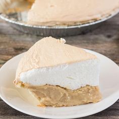 a piece of pie sitting on top of a white plate next to a pie pan