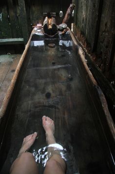 an old wooden boat is sitting in the water