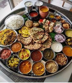 a platter filled with lots of different types of food on top of a table