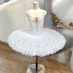 a white ballerina dress on display in a store