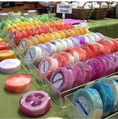 many different colored soaps are on the table