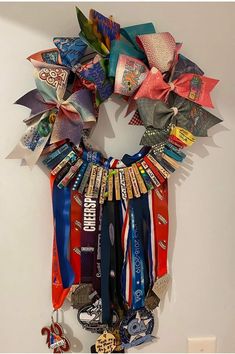 a wreath made out of ribbons hanging on the wall next to a keychain