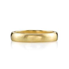 a yellow gold wedding ring on a white background