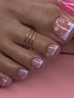 a close up of a person's hands with rings on their fingers and nail polish