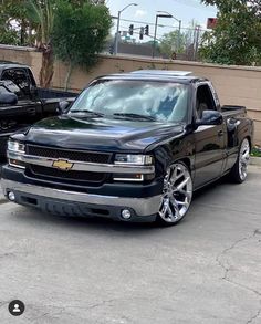 a black truck parked in front of a building