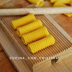 four pieces of pasta sitting on top of a wooden cutting board