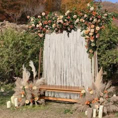 an outdoor wedding ceremony with flowers and candles