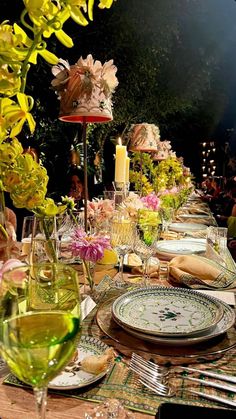 an image of a table setting with flowers and candles