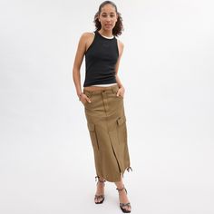 A ‘90s-inspired take on vintage utilitarian styles this maxi cargo skirt is designed with traditional workwear pockets to hold your on-the-go essentials. Crafted of organic cotton made without the use of harmful chemical fertilizers and pesticides the long silhouette is finished with a front vent for added mobility and tie details at the hem. Fall Cotton Skirt With Cargo Pockets, Fall Cotton Cargo Skirt With Pockets, Utility Cotton Cargo Skirt, Utility Cotton Skirt With Side Pockets, Cotton Utility Skirt With Side Pockets, Utility Cotton Cargo Skirt For Fall, Utility Denim Skirt With Cargo Pockets, Fall Utility Cotton Cargo Skirt, Spring Utility Skirt With Cargo Pockets