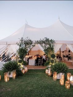 a large tent with candles in front of it