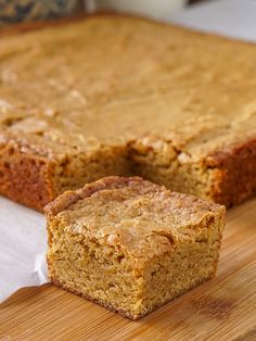 a piece of cake sitting on top of a wooden cutting board