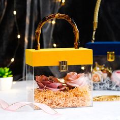 a small yellow and black purse sitting on top of a table