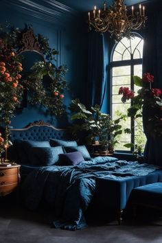 blue lavish dark moody romantic master bedroom. The deep blue walls and luxe bedding envelop you in calm, while the tufted headboard adds an air of elegance. Lush plants and floral arrangements breathe life into the space. The ornate chandelier and flowing curtains contribute to the room’s opulence. Perfect for retreating from the world and indulging in sumptuous comfort, this space is a serene oasis for rest and romance. Goth Bedroom Ideas, Academia Bedroom, Dark Blue Bedrooms, Goth Bedroom, Boho Bedroom Design, Dark Bedroom, Dark Home Decor, Bed Design Modern, Romantic Bedroom