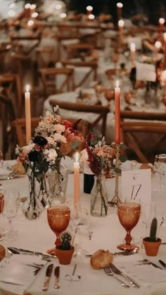 an image of a table setting with candles and flowers